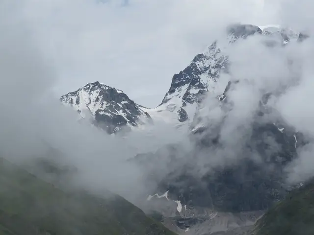 Glaciers at the head of the valley, breaking through cloud
