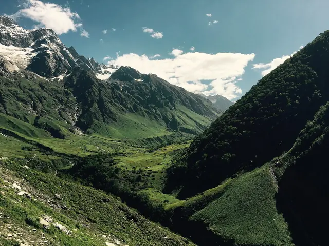 Green meadows sweeping up to the peaks in early summer