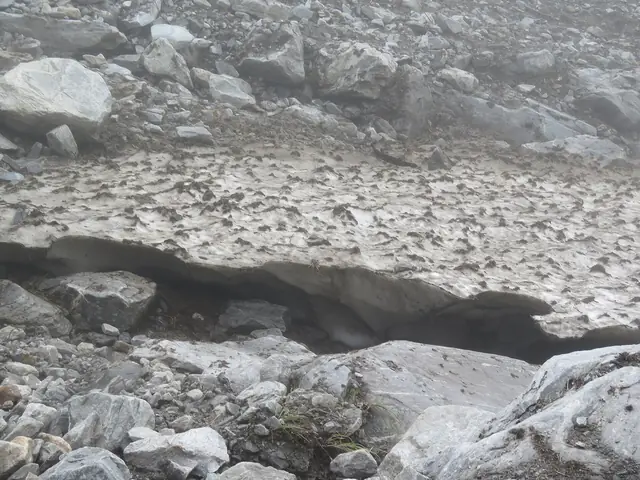 Crossing a snow bridge over a stream early in the season