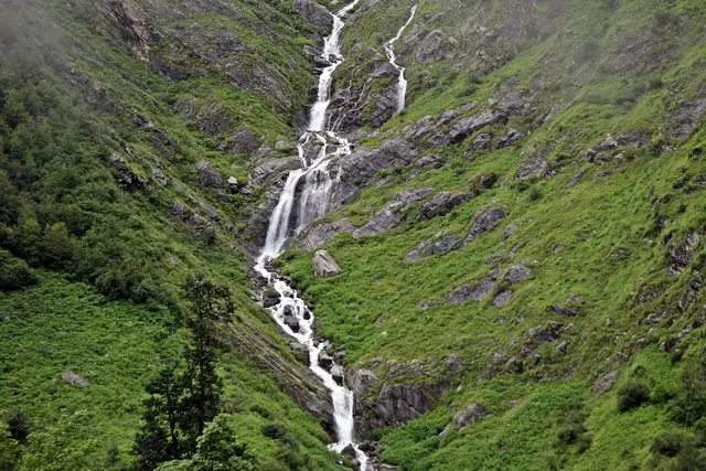 A cascade tumbling down the green slopes